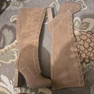 Tall tan lace up boats with small heel.